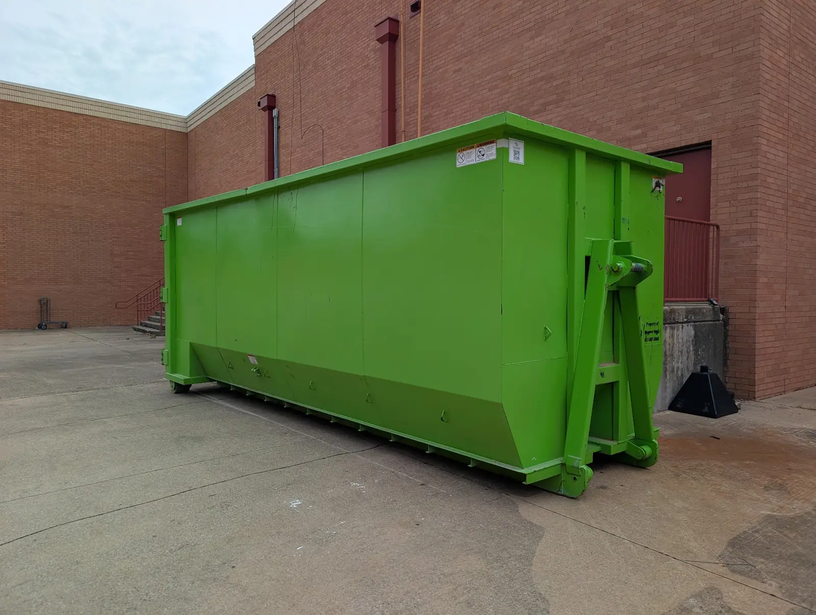 Large roll-off dumpster on a commercial job site